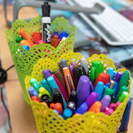 Pens and markers on a teachers desk